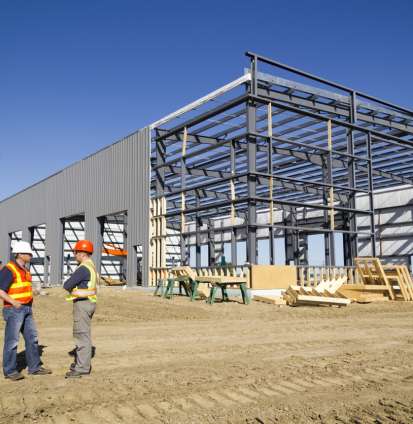 A royalty free image from the construction industry of two architects at a steel frame building site.